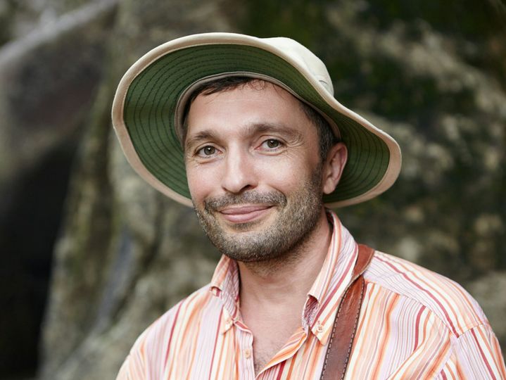 Science and environmental protection concept. Handsome ecologist with small beard wearing striped sh