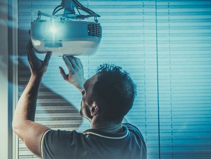 Men Adjusting Home Multimedia Projector