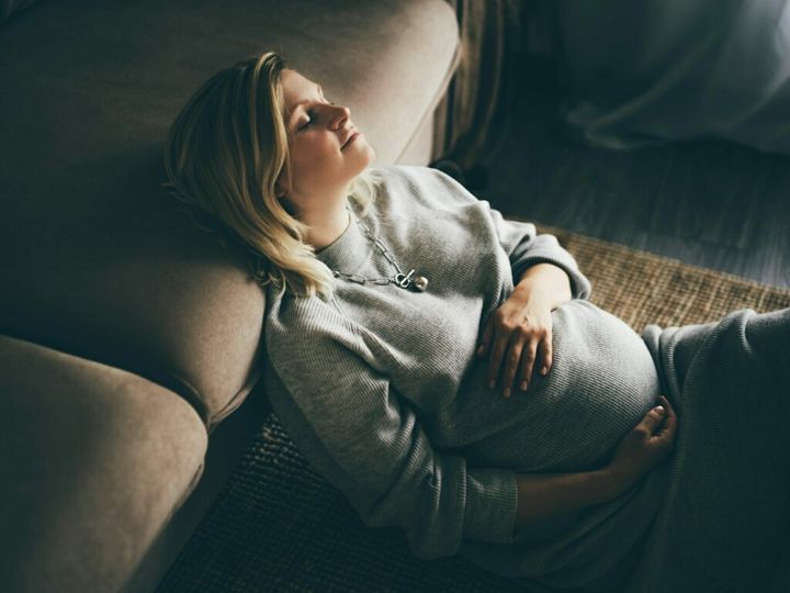 Cozy portrait of pregnant woman resting at home