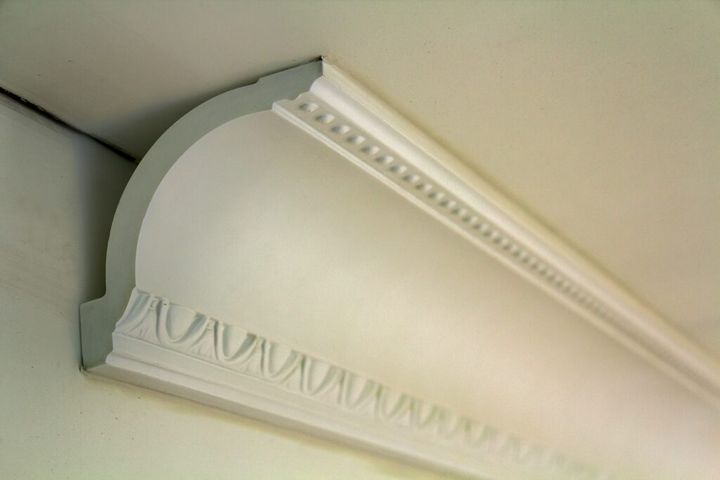 Close-up detail of decoration white molding connected with glue adhesive