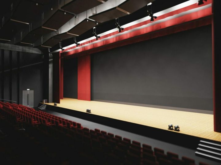 Theatre with empty stage in spotlight. Red theater curtain and seats