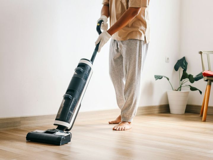 Man Vacuuming The Floor