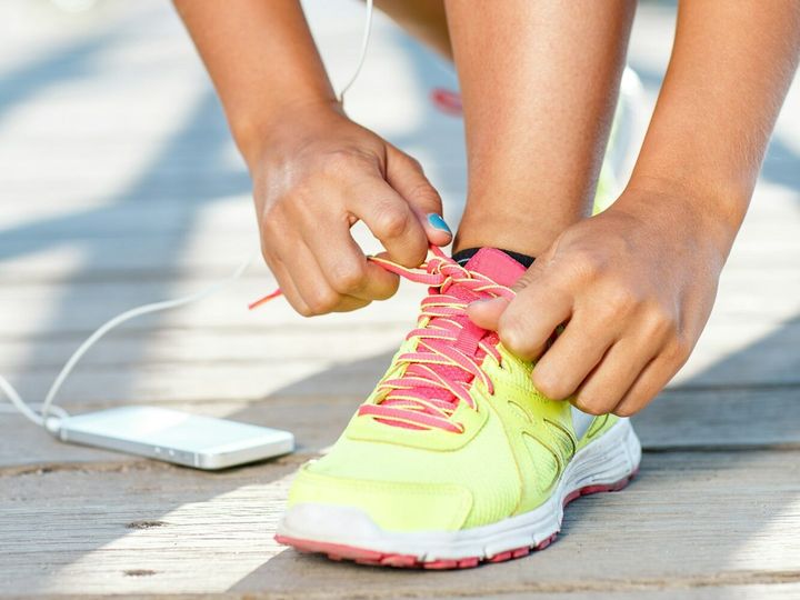 Running shoes - woman tying shoe laces. Closeup of female sport