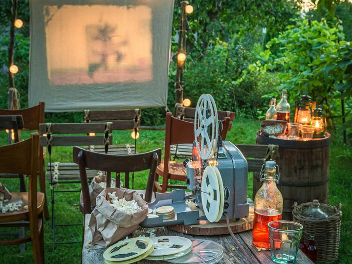 Cozy summer cinema with vintage projector in the evening