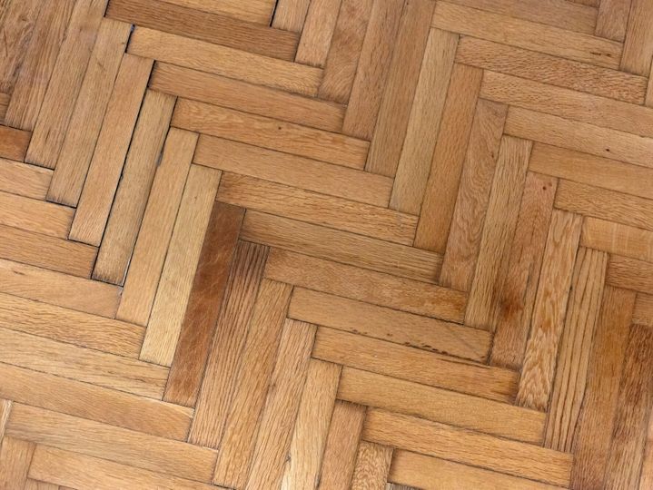 Herringbone pattern parquet wood floor texture. Wooden oak flooring background, overhead