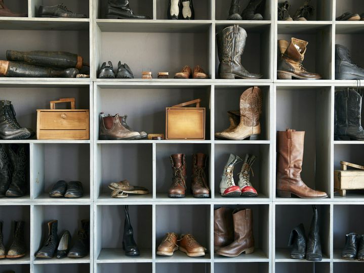 Display of boots and shoes on shelves in traditional shoe shop