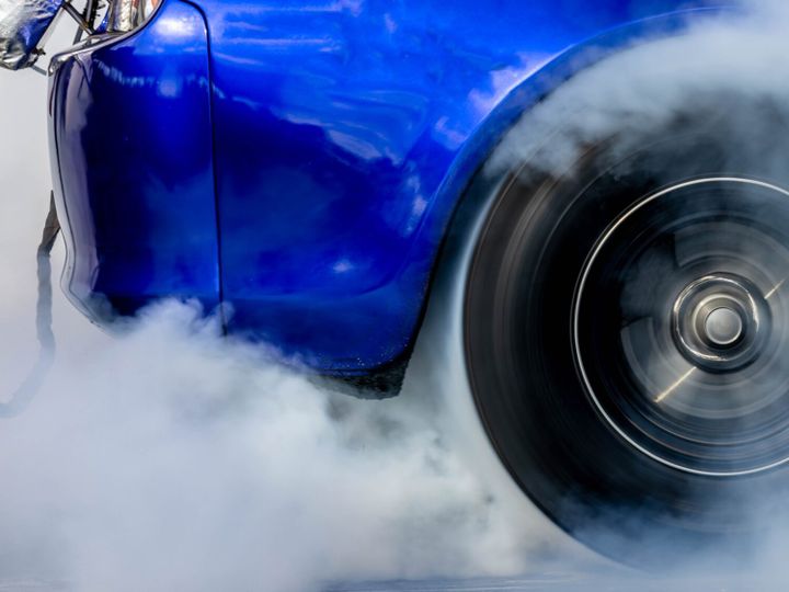 Car burnout wheels tire with white smoke,Car wheel burnout with smoke from the spinning tyre.