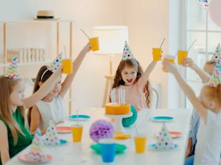 Group of cheerful preschool kids celebrate birthday together, have fun