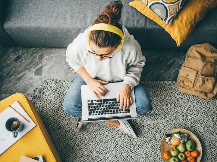 Young woman using laptop computer at home.