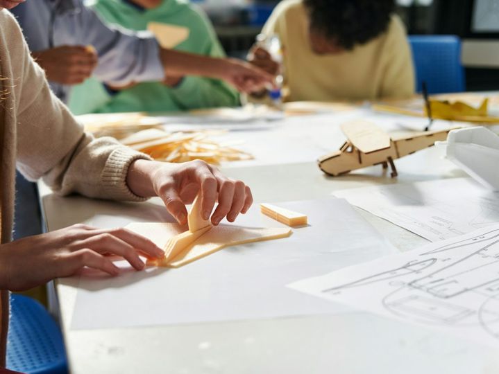 Schoolgirl Gluing Aircraft Model