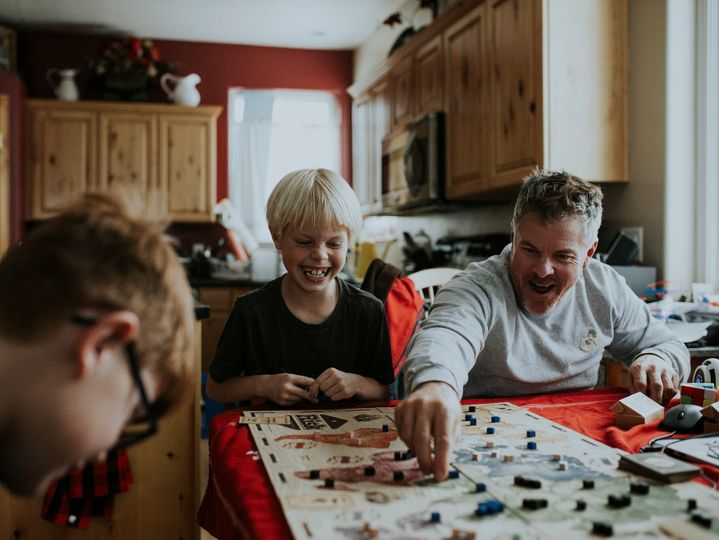 family playing board game together