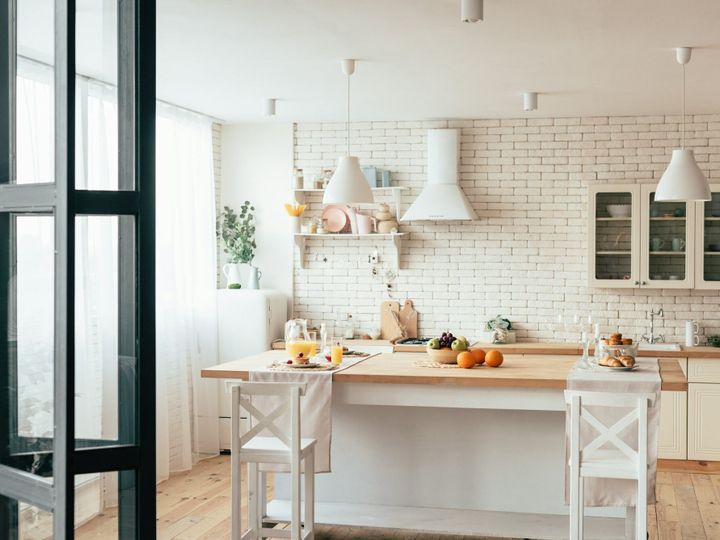 cozy modern kitchen with served table and chairs