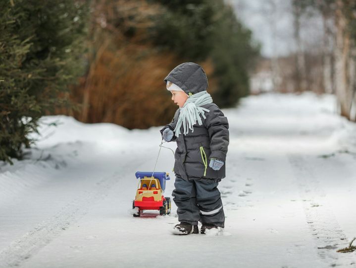 3 years old boy walk with plastic dump truck