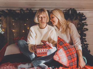 Happy women mothers are preparing for Christmas, New year pack gifts at home