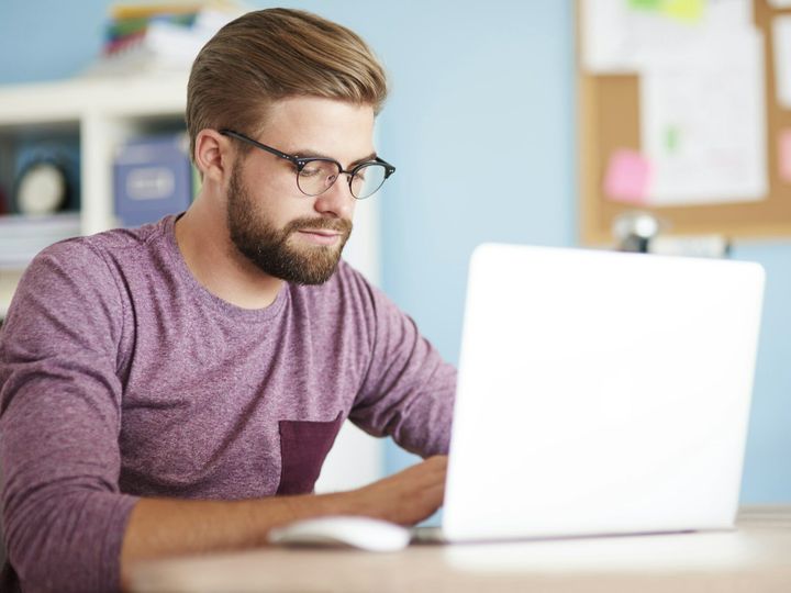 Busy man working on white laptop