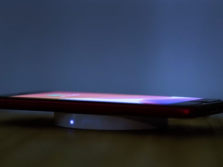 Wireless induction charger base for mobile phone.