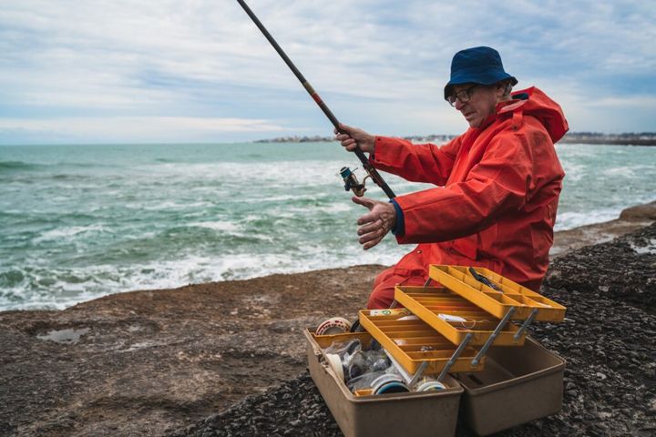 Old man fishing in the sea.