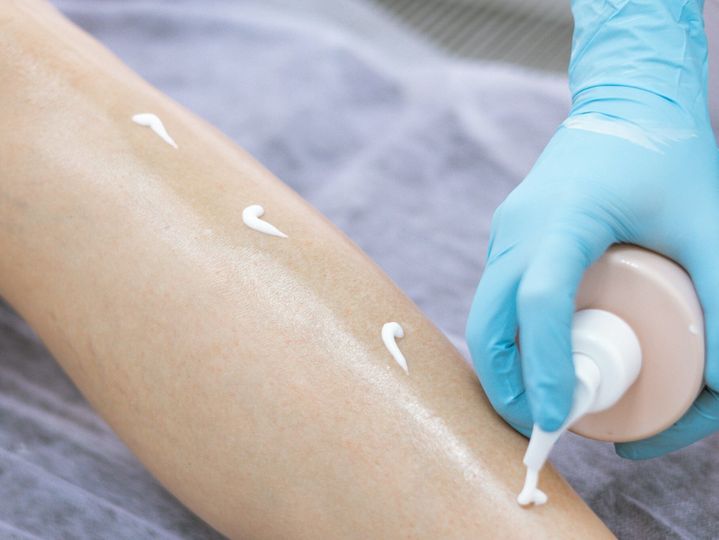 female legs after hair removal with sugaring procedure in beauty salon