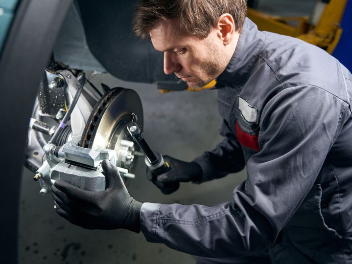 Mechanic doing inspection of the brake system
