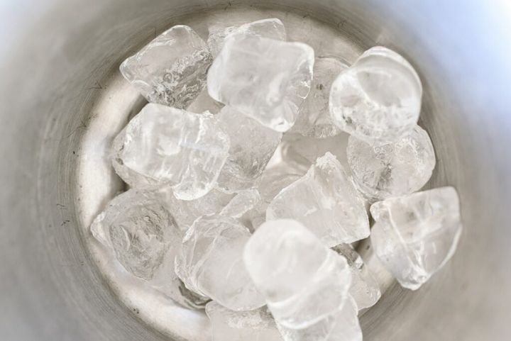 Cubed ice inside an ice bucket.