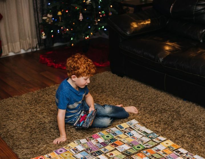 A little boy playing Pokémon cards