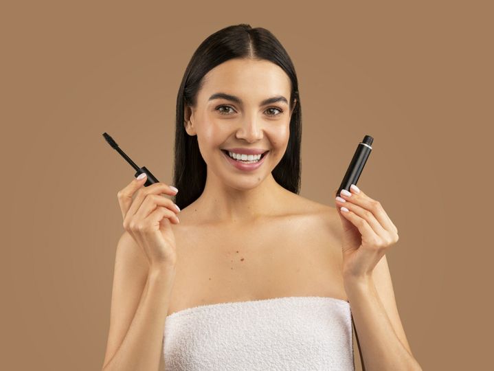 Beautiful young woman recommending brand new organic mascara