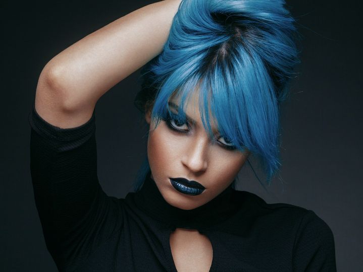 Portrait of a young woman with blue color hair