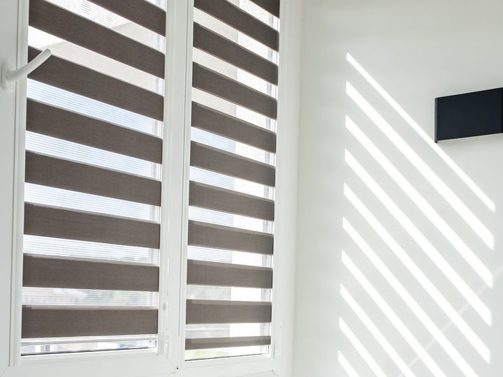 Roller blinds on balcony windows. Beautiful window blinds, sun protection