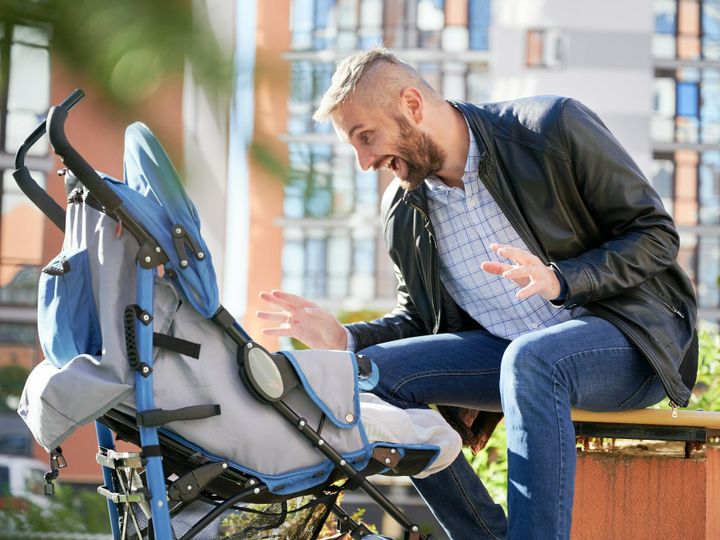 Young father and newborn baby on walk outdoor.