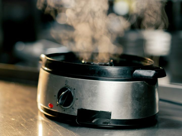 kitchen of the establishment on the cooking table there is a steamer in operation steam comes out of