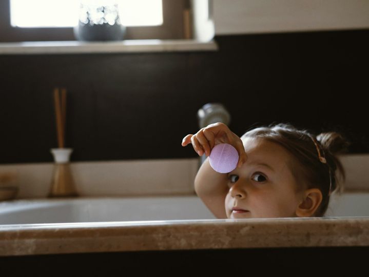 Child holding aromatic bath bomb