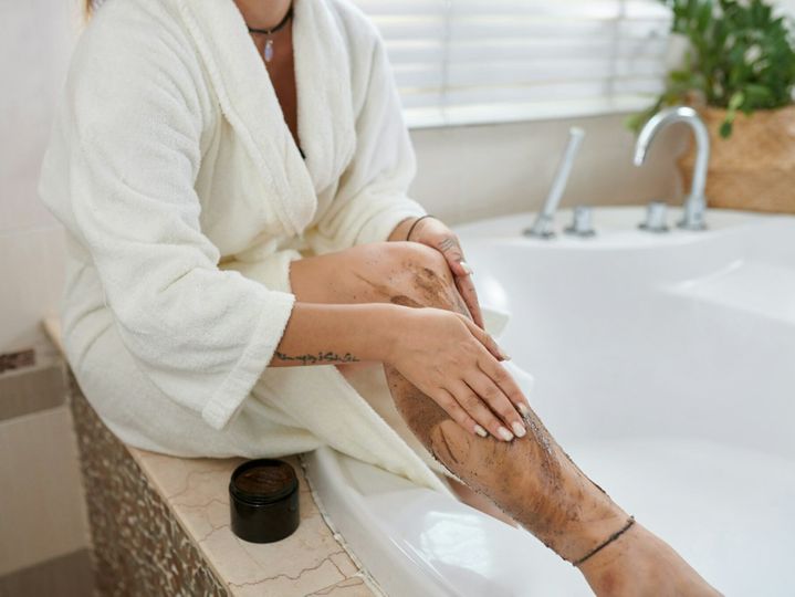 Applying body scrub or peeling on legs