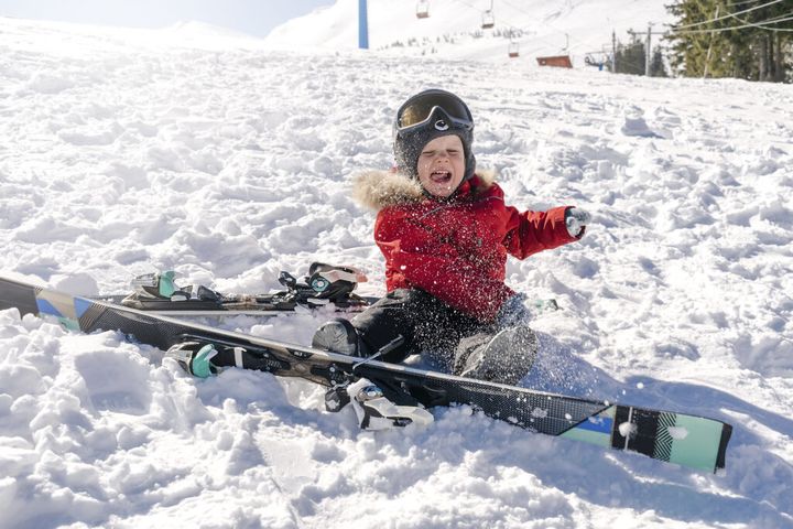 baby kid child boy having fun with snow, skis at winter holiday ski resort mountains