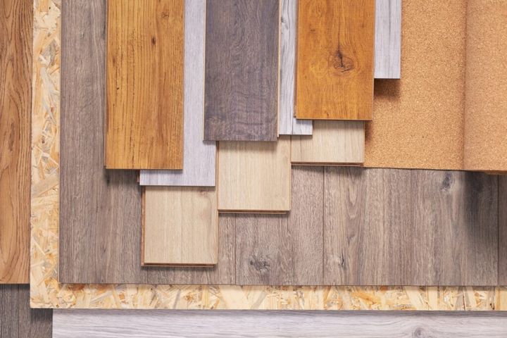 Laminate floor and cork roll on wood osb background texture. Wooden laminate floor and chipboard