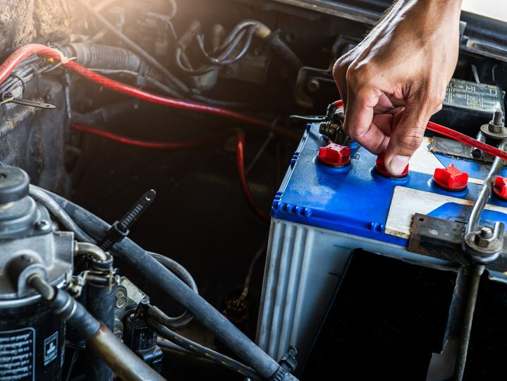 Hand worker service check car battery