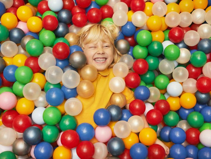 Boy in pool with balls