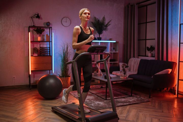Portrait of active and dynamic young charming woman doing sport fitness at home