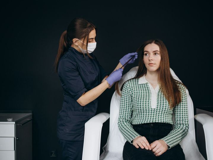 Trichoscope examination of hair, scalp and hair follicles of a young man. Copy space.