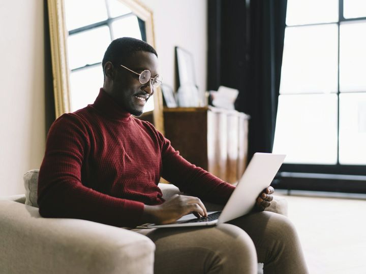 Happy man working on laptop