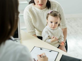 Pediatrician Meeting With Mother And Child In Hospital