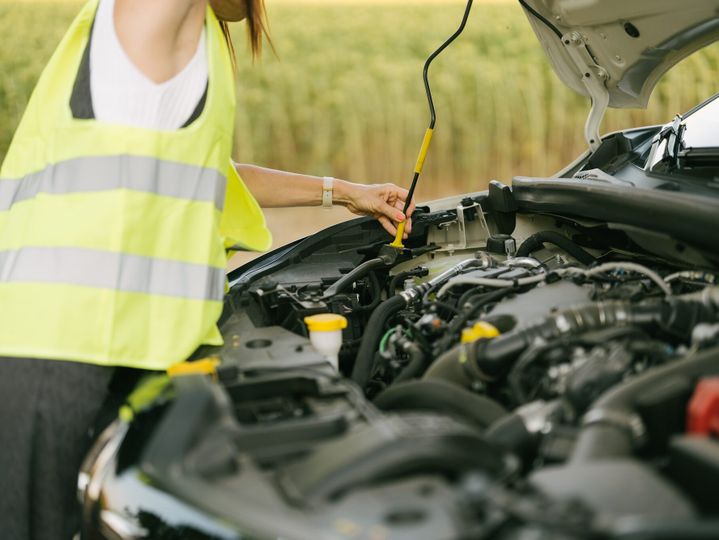 woman anchoring the hood rod in its groove