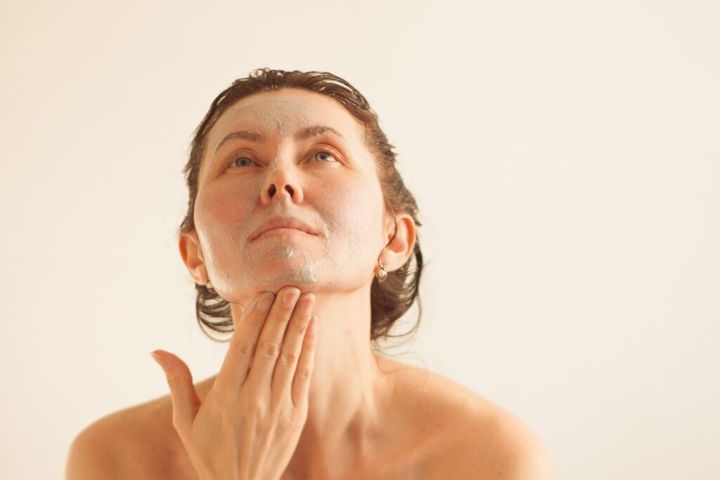 A woman does a facial peeling