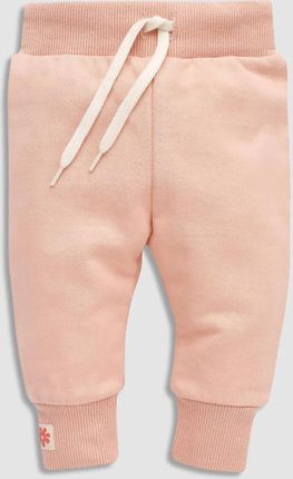 Spodnie dresowe w kolorze pudrowego różu ze sznurkiem w pasie i ściągaczami