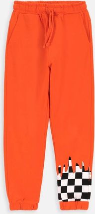 Spodnie dresowe pomarańczowe z nadrukiem na nogawce o fasonie SLIM