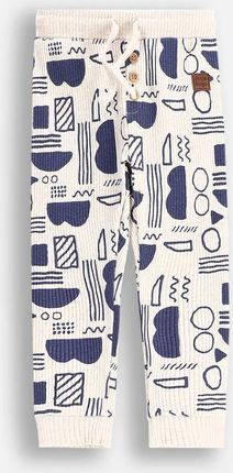 Spodnie dresowe beżowe prążkowane z nadrukiem na całości